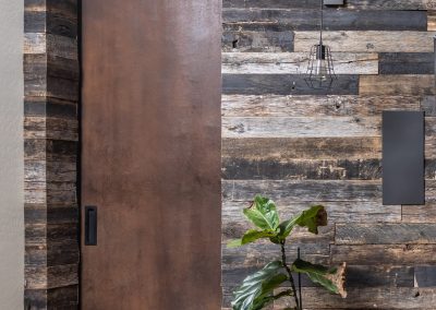 Metal Door & Speckled Black Wood Wall